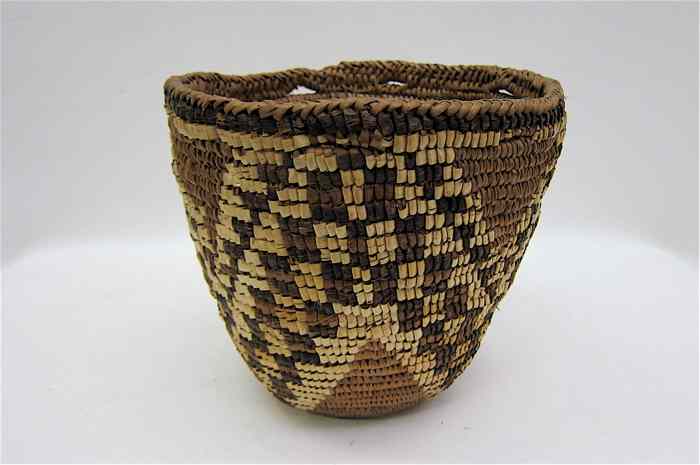 Appraisal: NISQUALLY INDIAN BASKET coiled from cedar root and bark Diameter