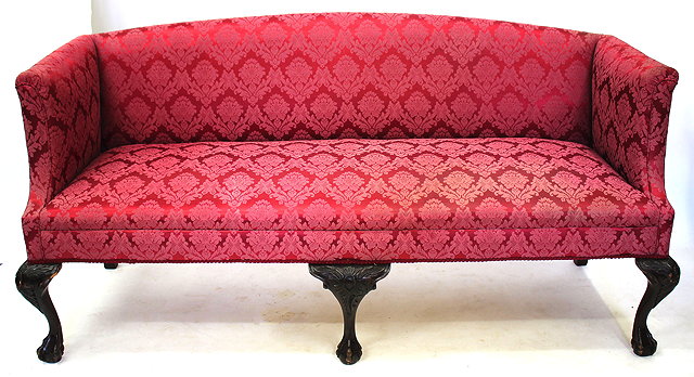 Appraisal: A GEORGIAN STYLE SOFA with arching back upholstered in red