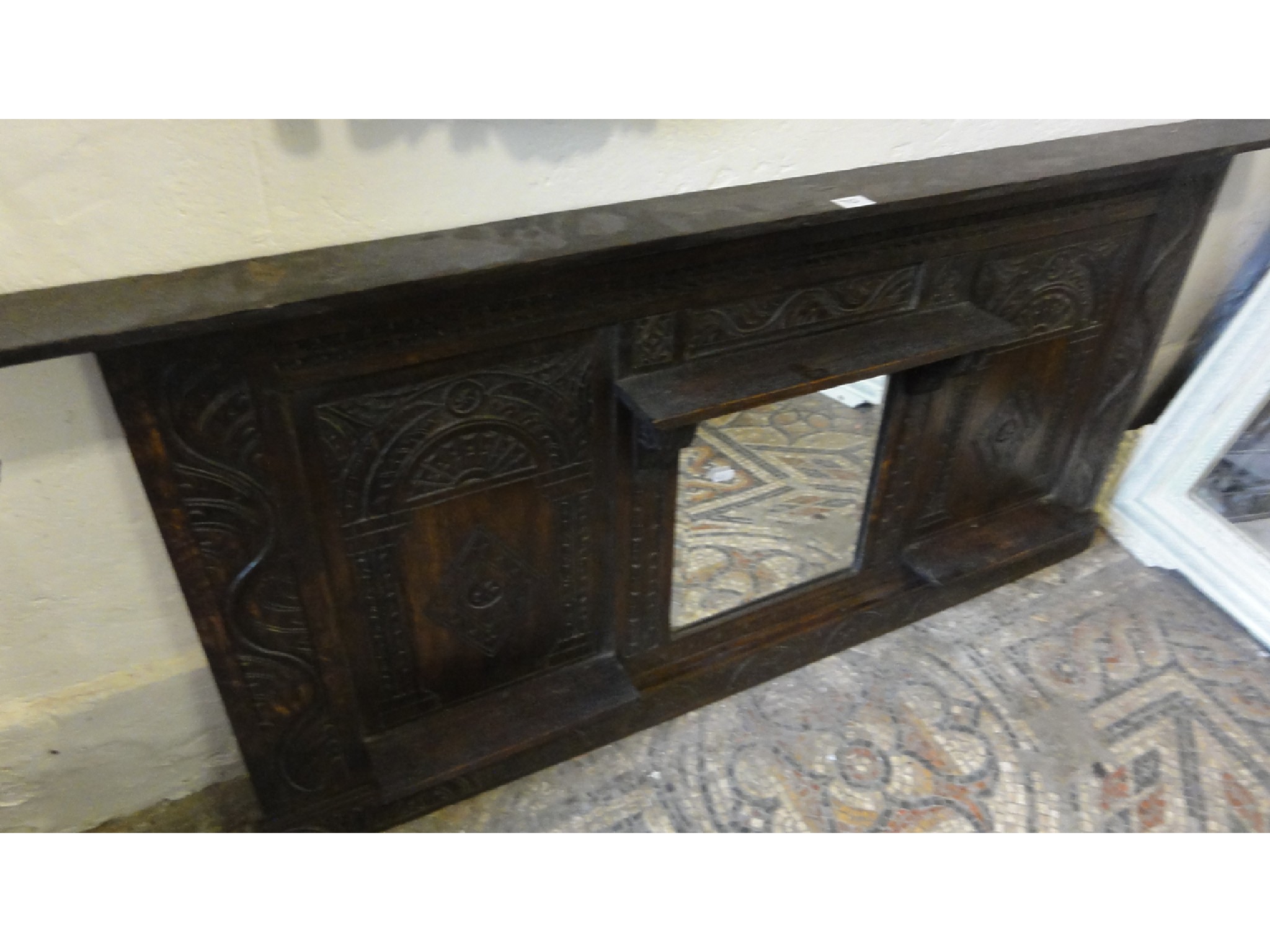 Appraisal: An antique oak framed overmantle with carved arcaded and lozenge