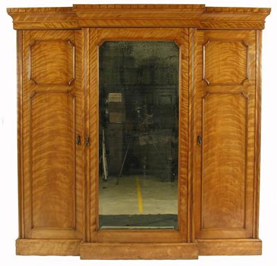 Appraisal: A Victorian satin walnut breakfront wardrobe with detachable cavetto moulded