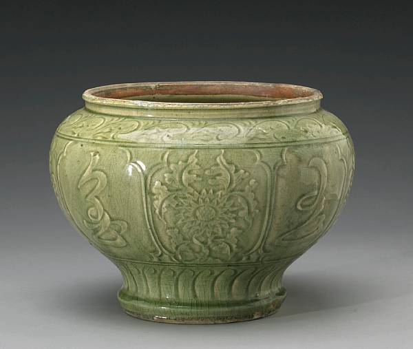 Appraisal: A Zhejiang celadon glazed jar with carved decoration Ming Dynasty