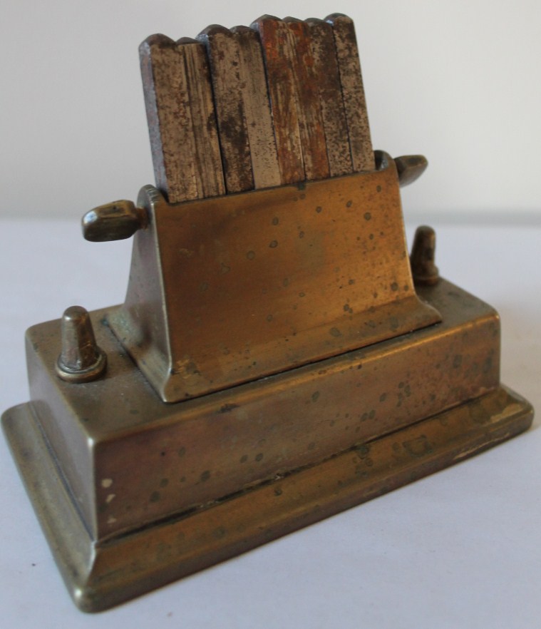 Appraisal: A brass punch stand and a Belgian map cutter