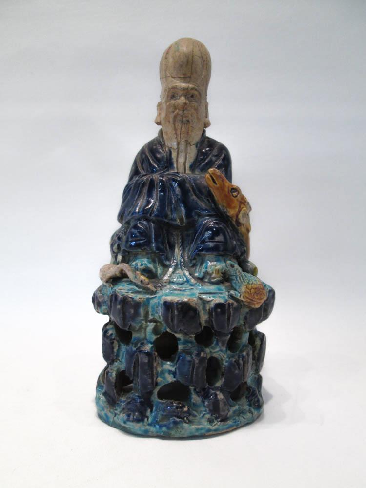 Appraisal: CHINESE POTTERY SCULPTURE depicting the God of Longevity seated with