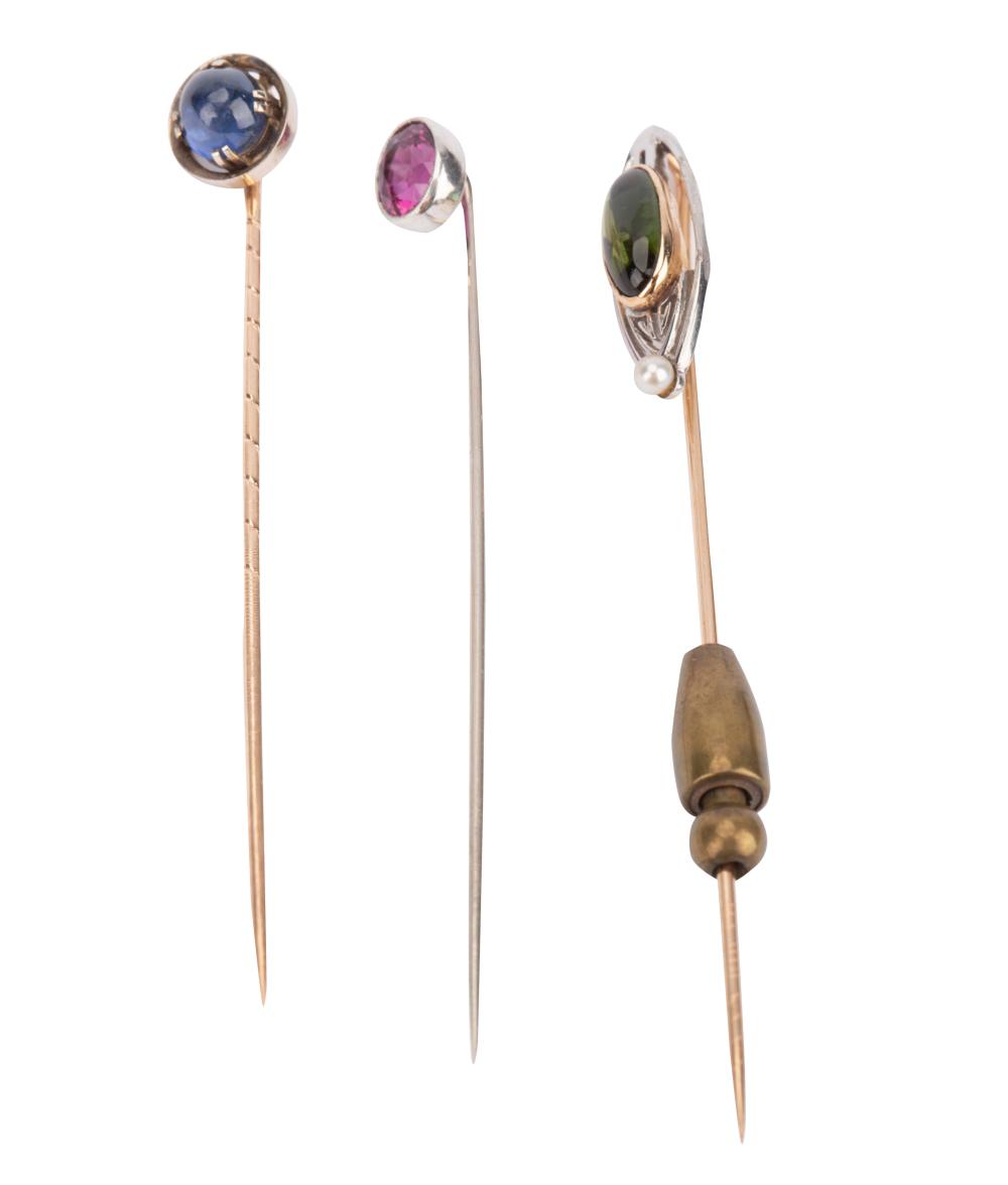 Appraisal: THREE GEM-SET STICKPINScomprising one karat yellow gold stick pin centering