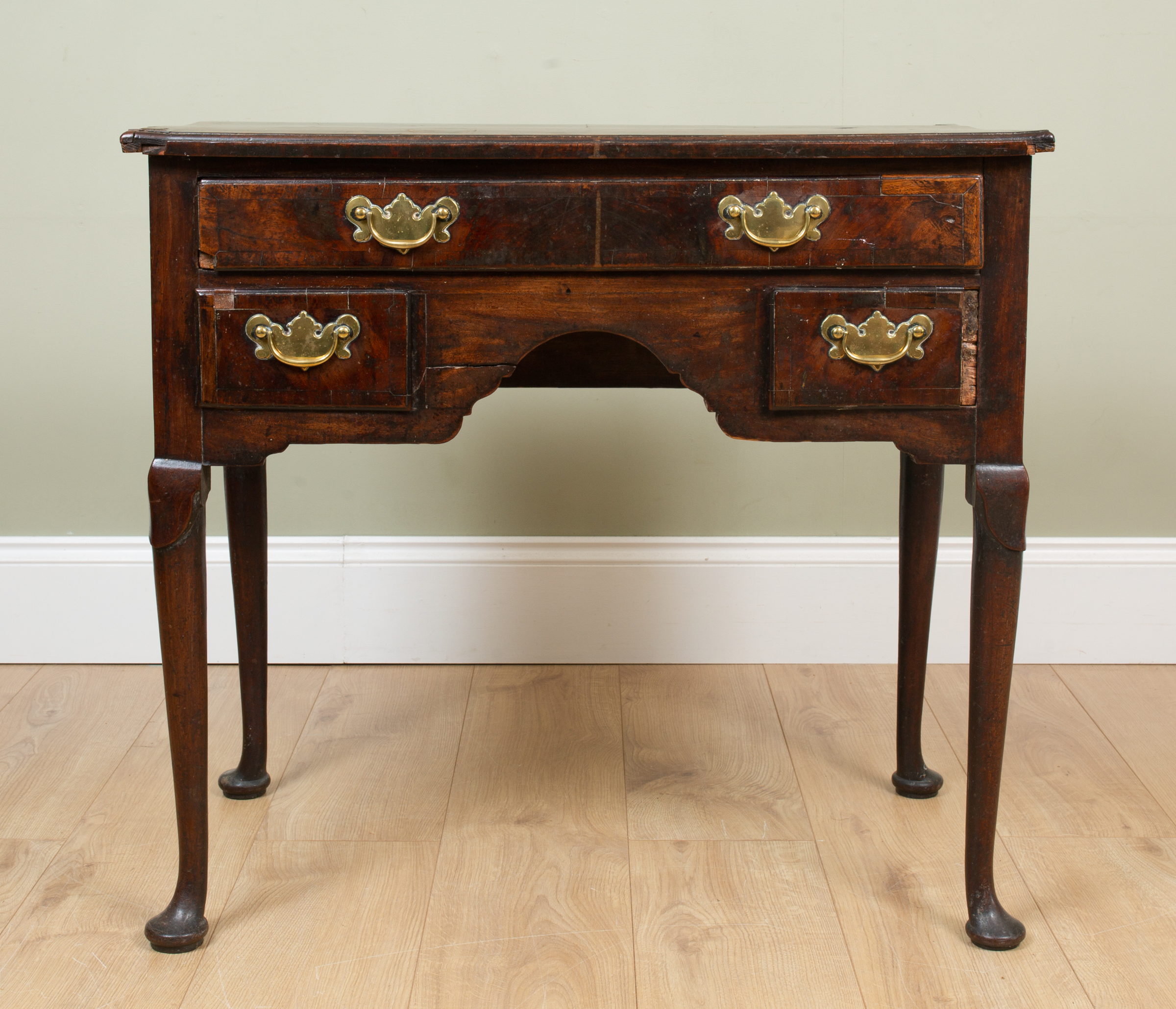 Appraisal: A George II walnut lowboy with quartered veneers to the