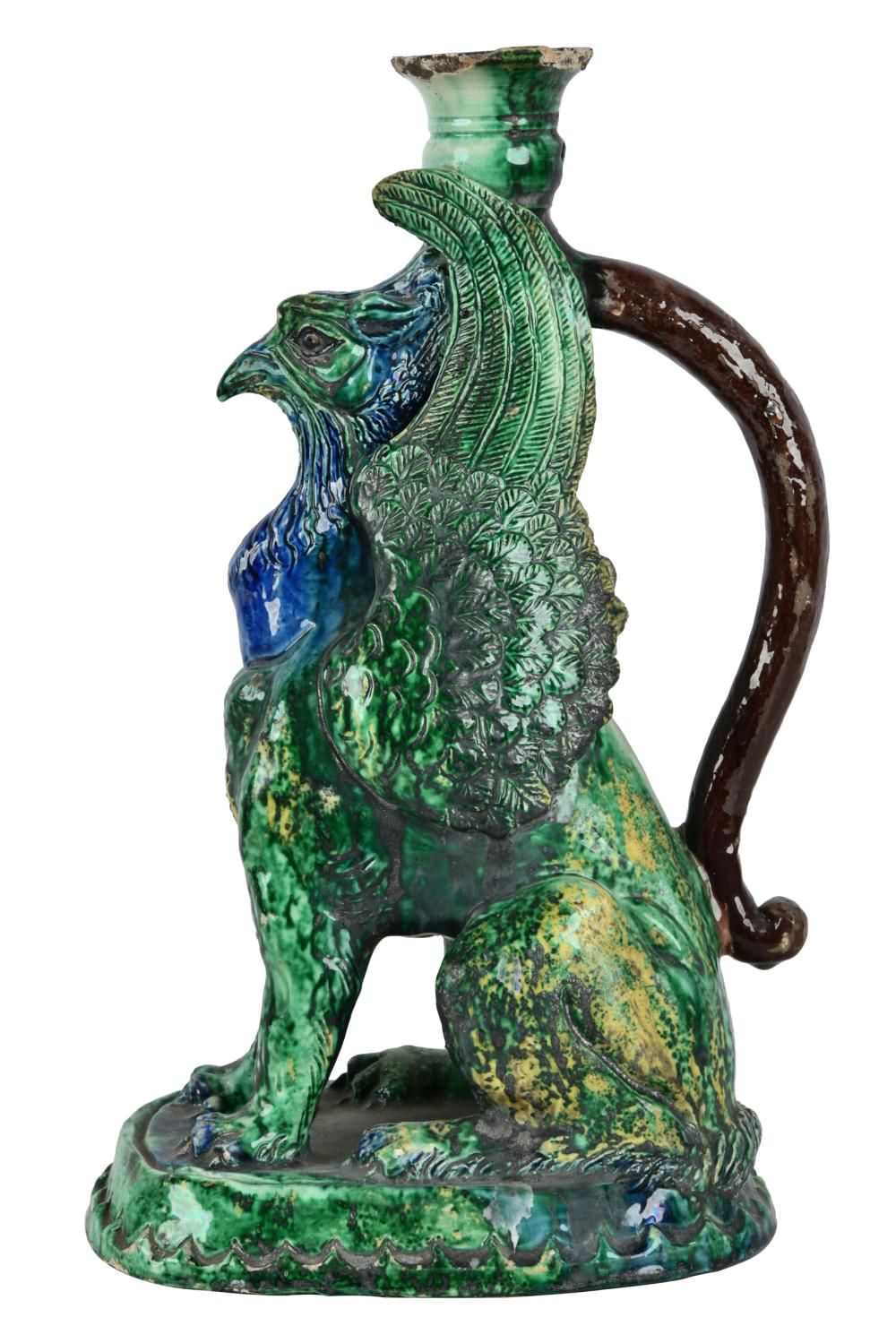 Appraisal: MAJOLICA GRIFFIN-FORM CANDLESTICKmolded mark to underside Provenance The Estate of