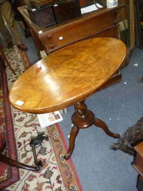 Appraisal: A WALNUT OVAL TOPPED OCCASIONAL TABLE with inlaid top over