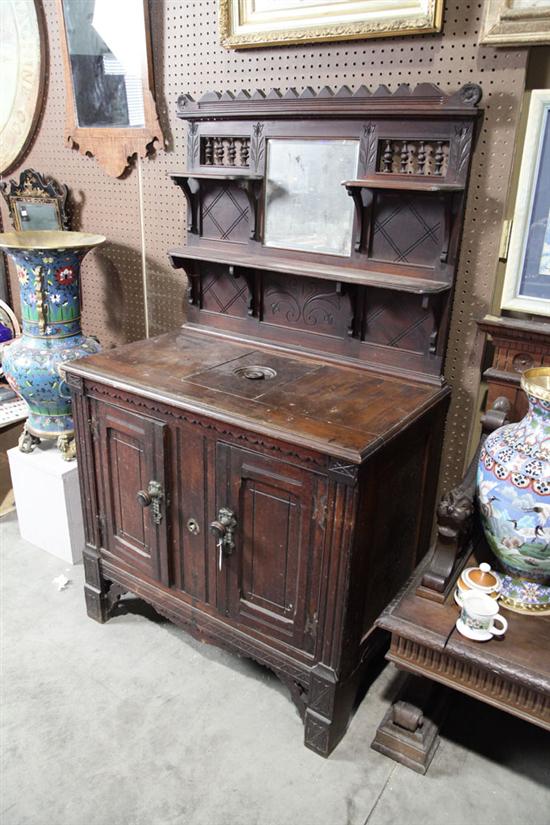 Appraisal: VICTORIAN ICE BOX Walnut having a mirrored and incised back