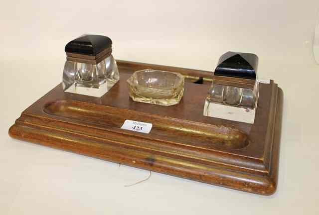 Appraisal: AN EDWARDIAN WALNUT INKSTAND of rectangular form fitted with two