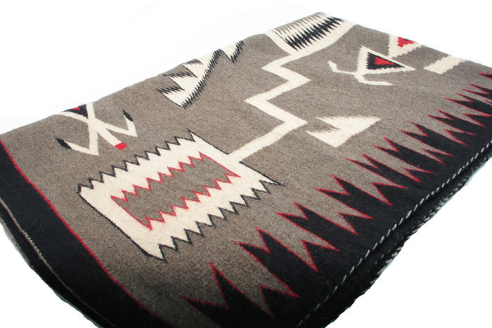 Appraisal: A TRADITIONAL NAVAJO INDIAN HAND WOVEN RUG having a sacred