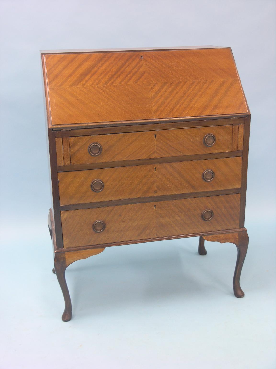 Appraisal: An early th century mahogany bureau quarter-veneered fall-front enclosing fittings