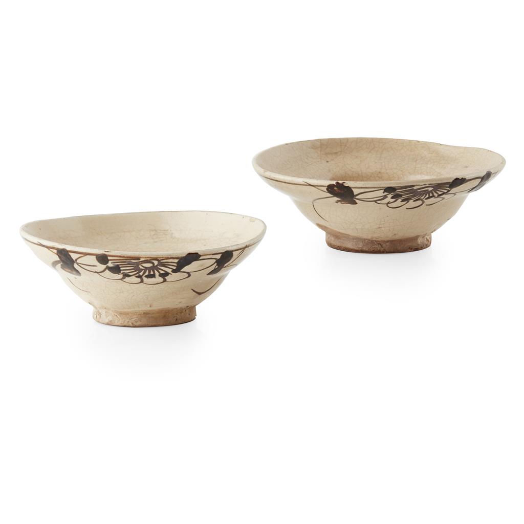 Appraisal: PAIR OF CIZHOU POTTERY BOWLS of ogee form partially covered