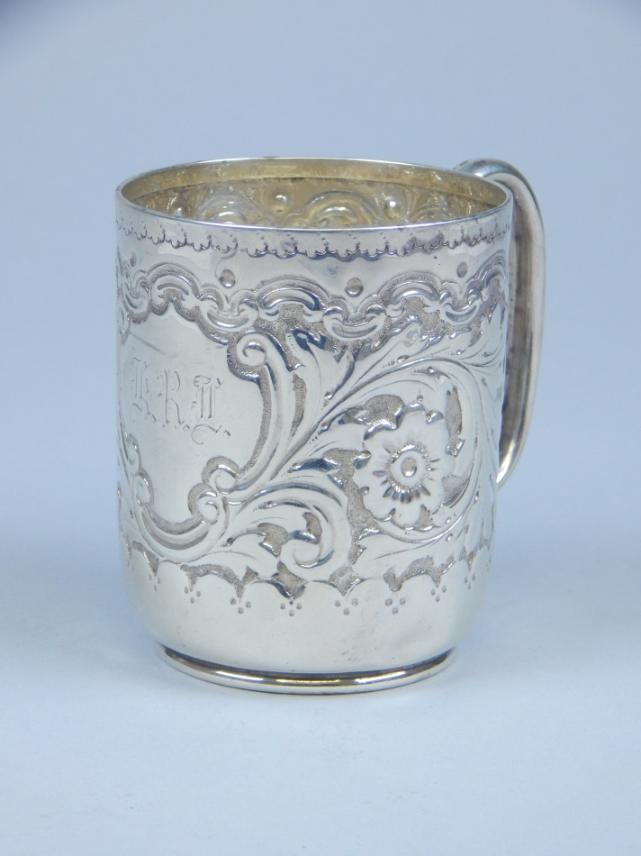 Appraisal: A late Victorian silver cylindrical christening mug embossed with flowers