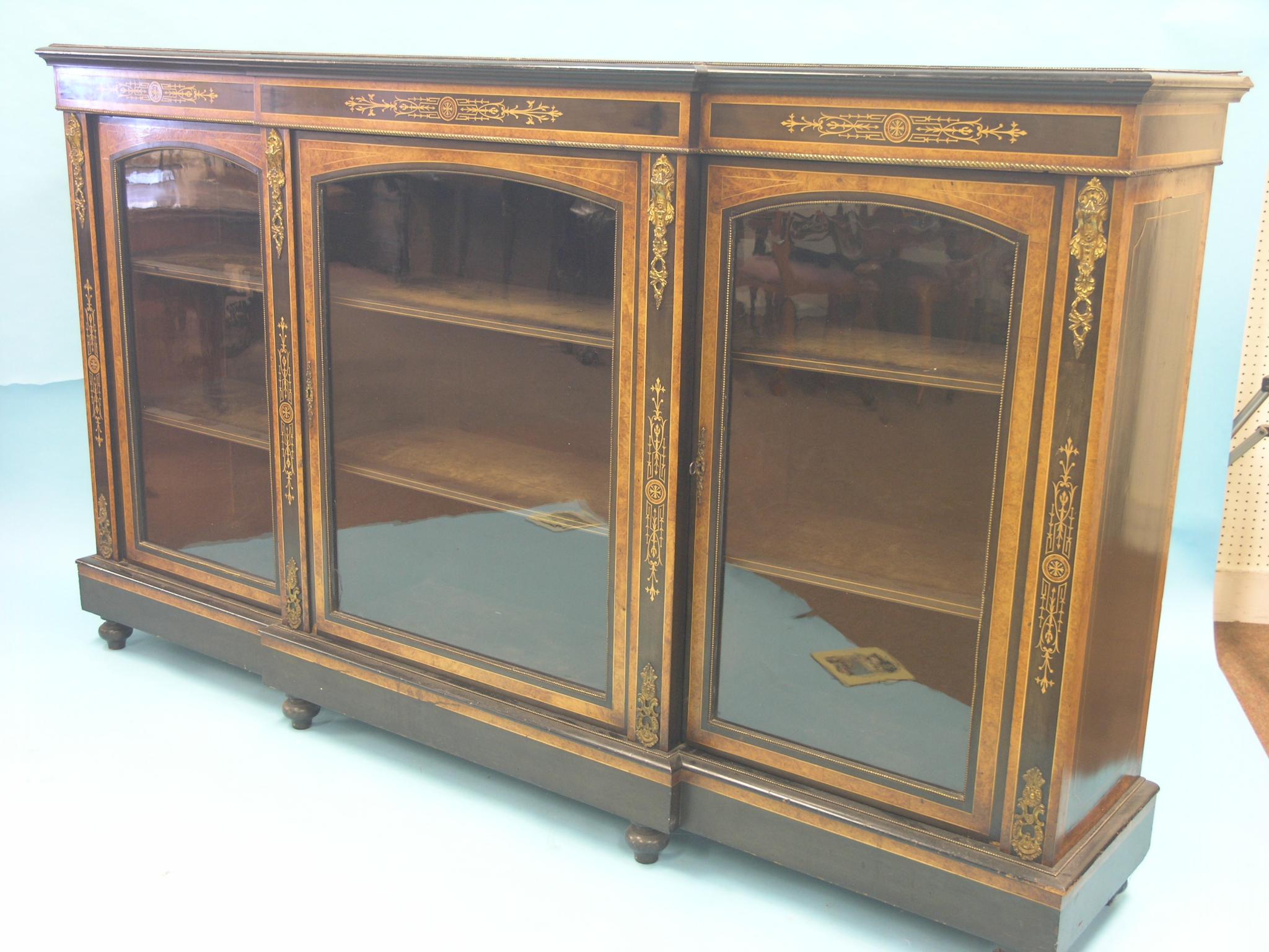 Appraisal: A Victorian ebonised and burr yew break-fronted credenza six velvet-lined