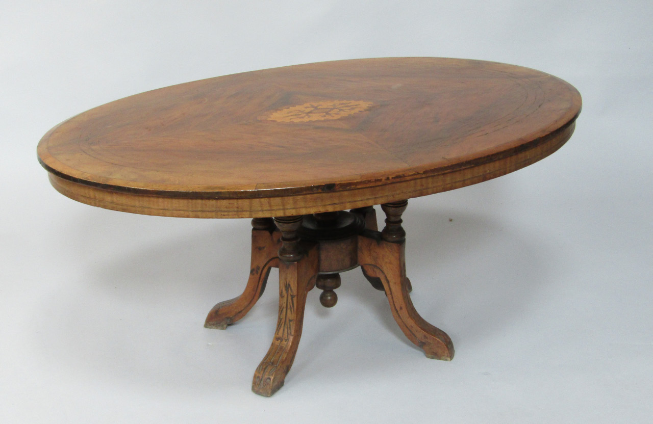 Appraisal: A Victorian walnut and inlaid oval loo table cut down