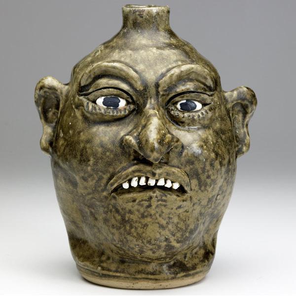 Appraisal: LANIER MEADERS Face jug with clay teeth covered in alkaline