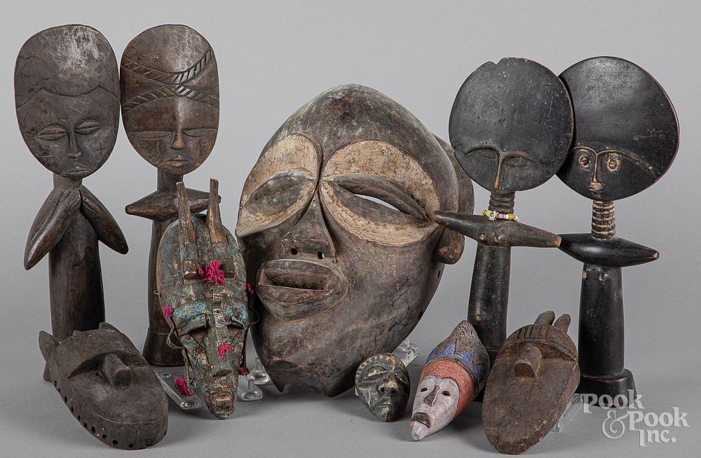 Appraisal: African carved wood masks and figures African carved wood masks