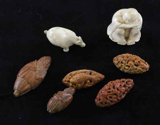 Appraisal: Five Chinese peach stone carvings two carved with multiple monkeys