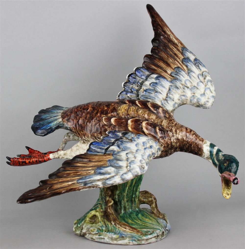 Appraisal: CONTINENTAL MAJOLICA MODEL OF A DUCK IN FLIGHT naturalistically colored