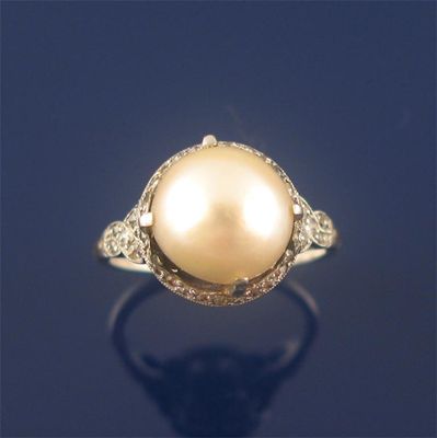 Appraisal: A cultured pearl and diamond set dress ring the pearl