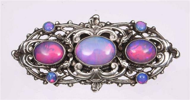 Appraisal: AN ARTS AND CRAFTS OPAL BROOCH three oval graduated backed