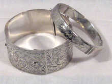 Appraisal: Two engraved silver bangles circa