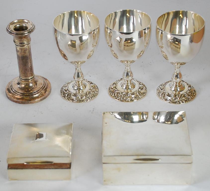 Appraisal: TWO SILVER CIGARETTE BOXES a weighted silver dwarf CANDLESTICK and