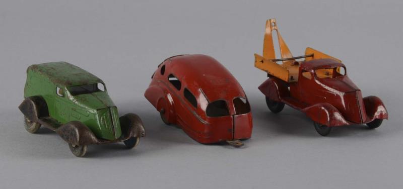 Appraisal: Lot of Trucks and One Trailer Three streamlined tin toys