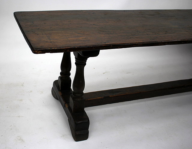 Appraisal: A REFECTORY TYPE DINING TABLE with dark stained rectangular pine