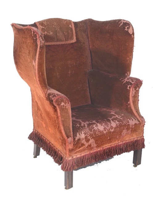 Appraisal: A GEORGIAN STYLE WING CHAIR on square cut supports with