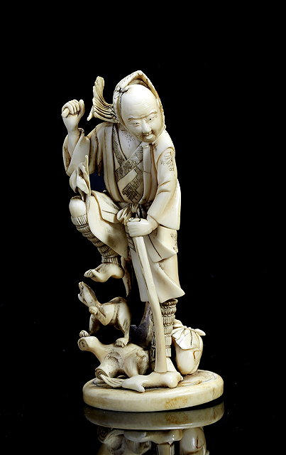 Appraisal: A Japanese ivory okimonoMeiji period - a farmer startled by