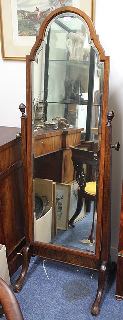 Appraisal: A MAHOGANY CHEVAL MIRROR the bevelled mirror plate with arching