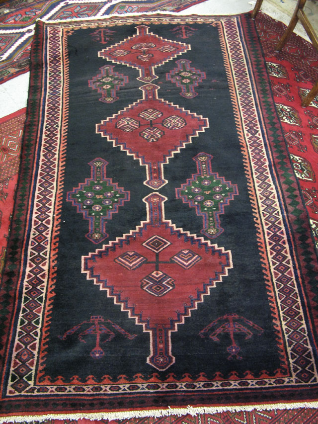 Appraisal: PERSIAN TRIBAL AREA RUG northwestern Iran multiple geometric medallion design