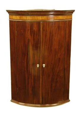 Appraisal: A George III mahogany bowfront hanging corner cupboard with a