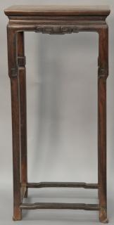 Appraisal: Oriental hardwood tall stand with carved frieze and stretcher base