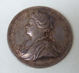 Appraisal: A silver medallion commemorating Queen Anne the obverse with the