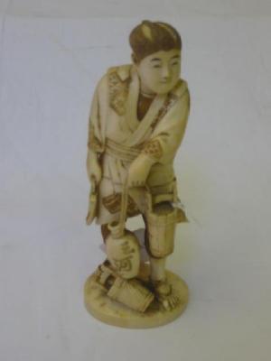 Appraisal: AN IVORY OKIMONO carved as a gentleman wearing traditional robes