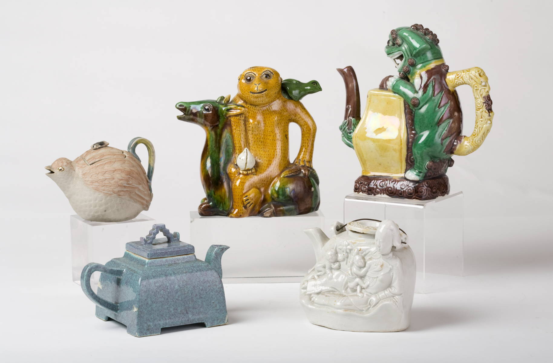 Appraisal: COLLECTION OF FIVE CHINESE POTTERY AND PORCELAIN TEAPOTS INCLUDING FIGURAL