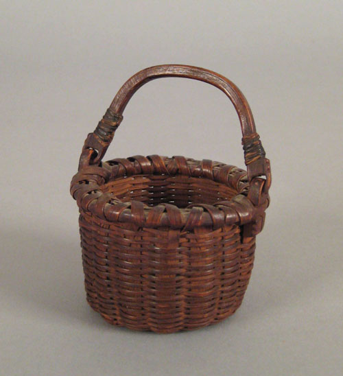 Appraisal: Miniature swing handled basket th c retaining a wonderful early