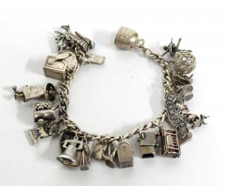 Appraisal: Sterling Silver Bracelet with Assorted Charms The sterling silver chain