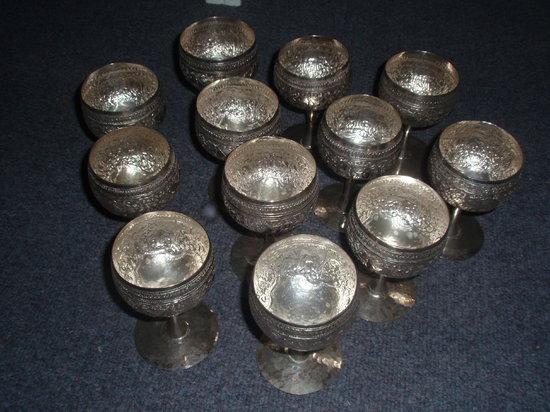 Appraisal: Twelve Indian goblets embossed elephants in foliage on pedestal bases