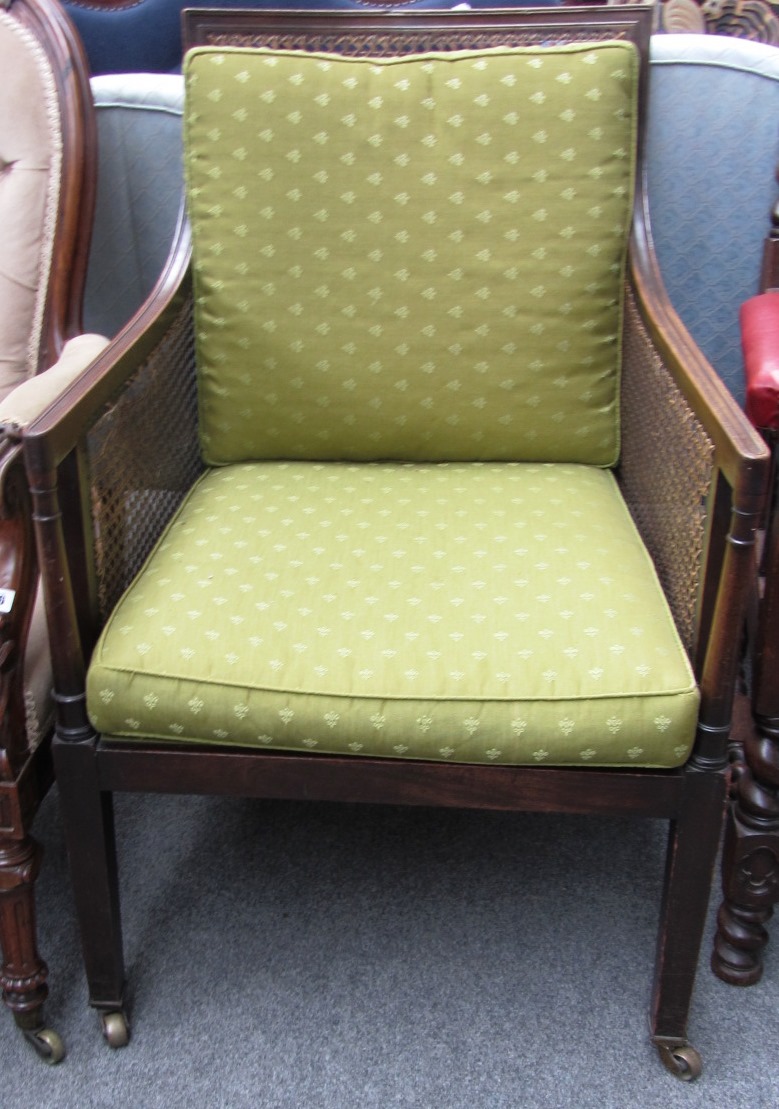 Appraisal: An early th century mahogany framed bergere on tapering square