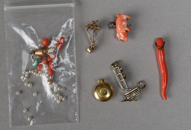 Appraisal: A COLLECTION OF SIX LOOSE CHARMS one of a toboggan