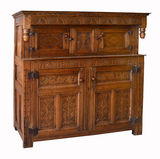 Appraisal: A TH CENTURY STYLE OAK COURT CUPBOARD the panelled doors