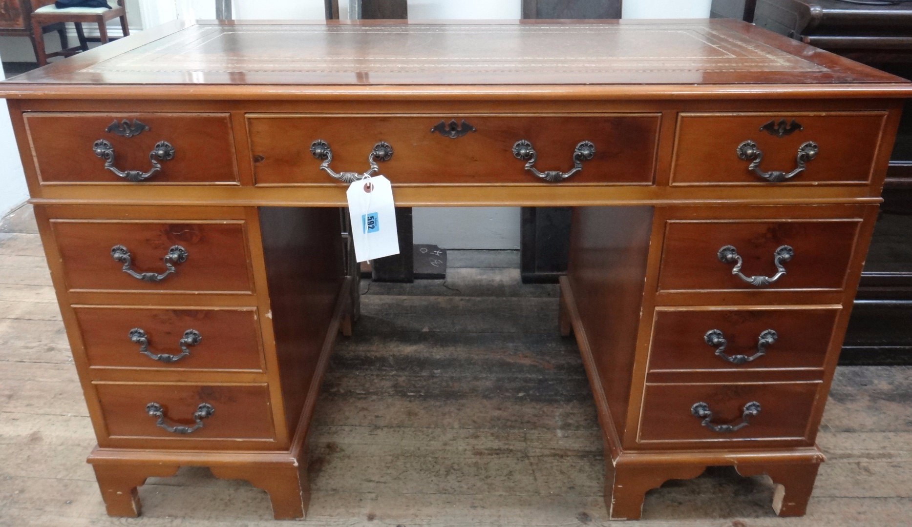 Appraisal: A reproduction yew wood pedestal desk fitted with eight drawers