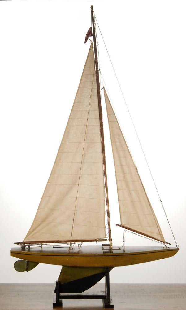 Appraisal: BERMUDA-RIGGED POND BOAT With green and beige hull and varnished