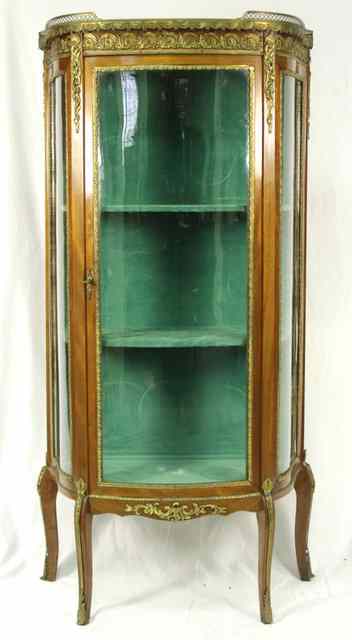 Appraisal: A Louis XVI style marble topped display cabinet with bowfronted