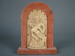 Appraisal: A German carved ivory plaque Pieta arched top height cm