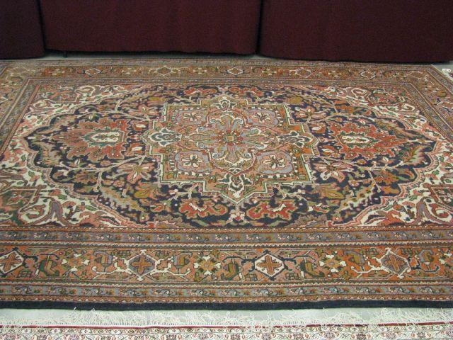 Appraisal: Heriz Persian Handmade Room Size Rug central medallion earthtones '