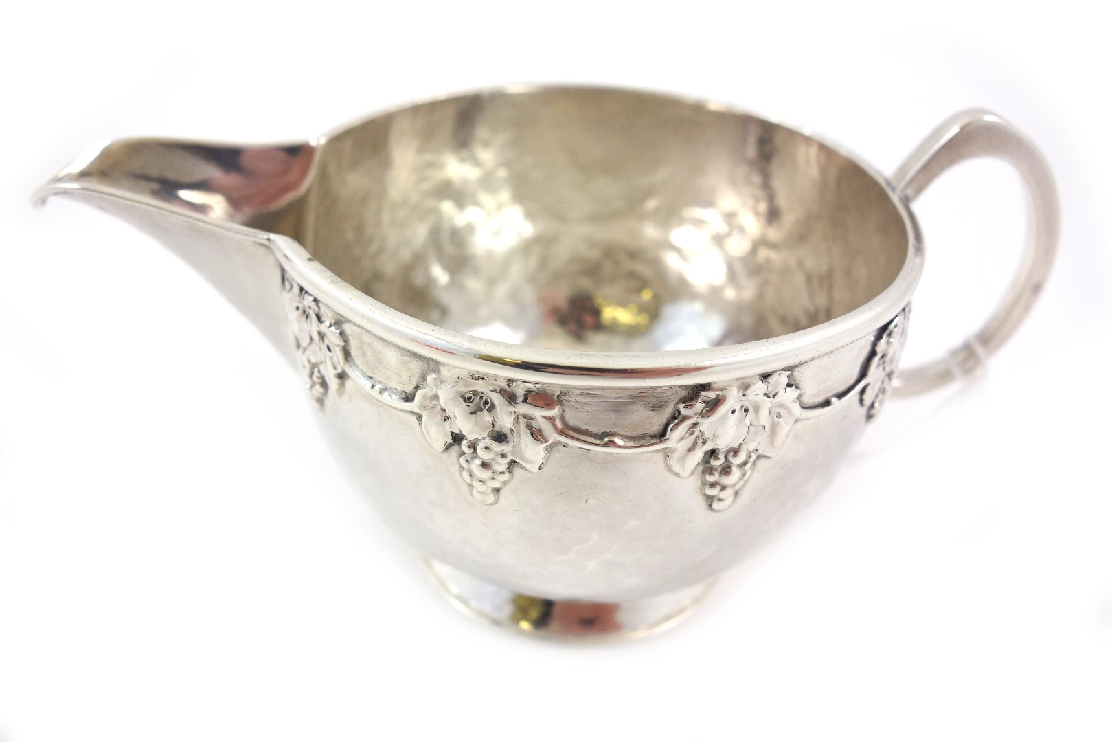 Appraisal: An Arts Crafts spot hammered circular silver milk jug A